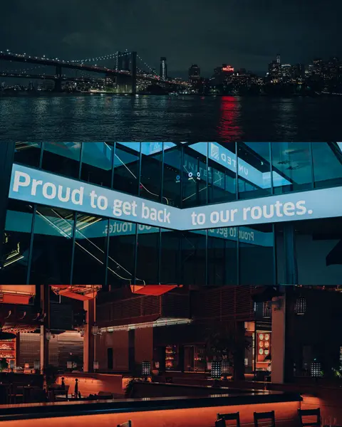 Three-panel night composite: lit suspension bridge over water, glowing billboard reading Proud to get back to our routes on a glass building, and warm-lit empty bar interior.